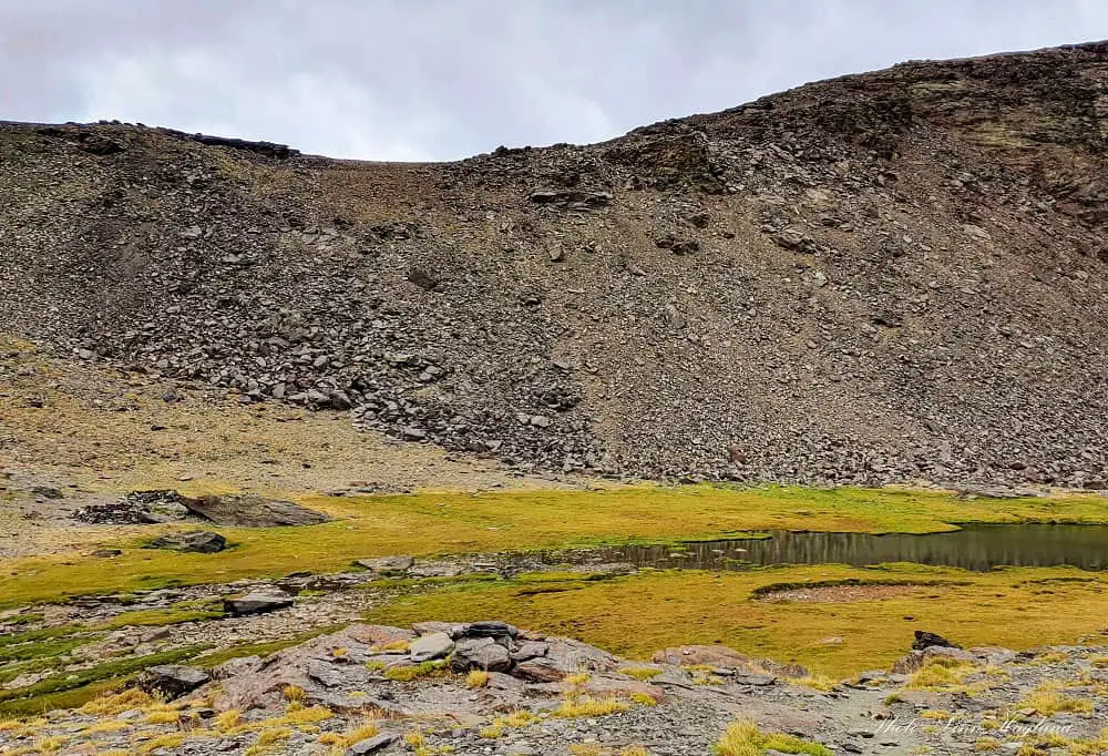 A lake at Siete Lagunas and the trail to Mulhacen.