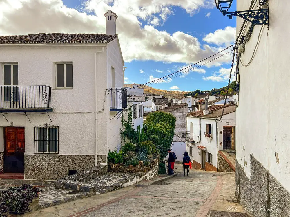 People walking through Igualeja village.