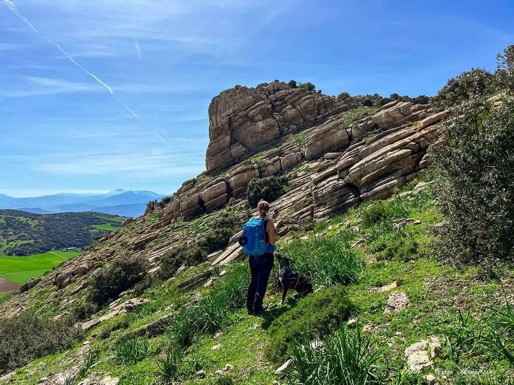 Me and Atlas walking towards a large, eroded rock.