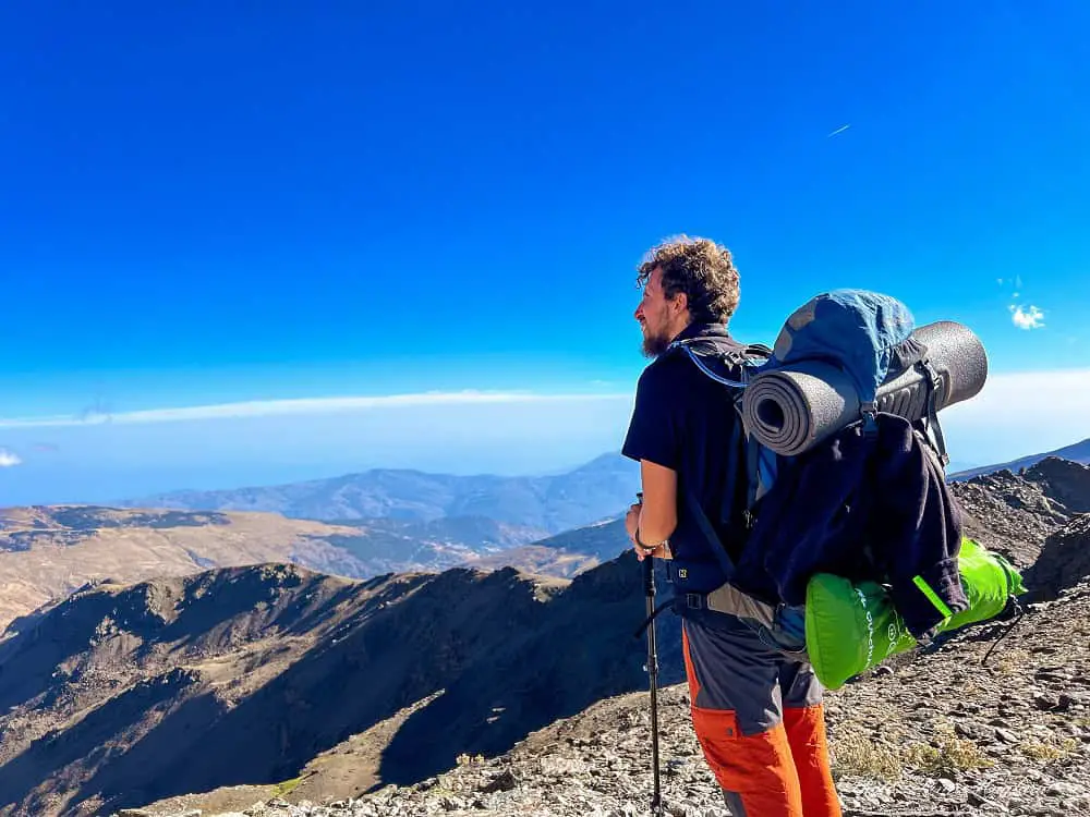 Mohammed Hiking in Sierra Nevada with his backpack and hiking poles.