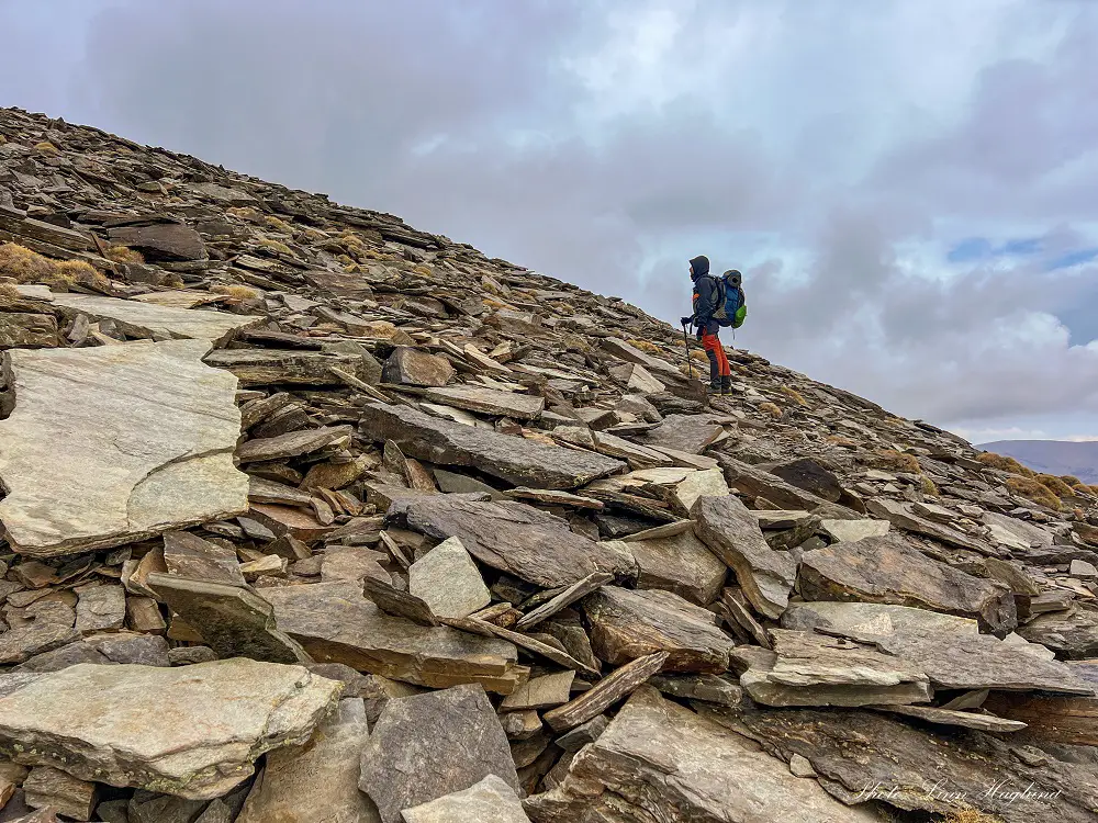 On the way to Alcazaba in Sierra Nevada Spain, Mohammed standing in a pile of rocks looking uphill.